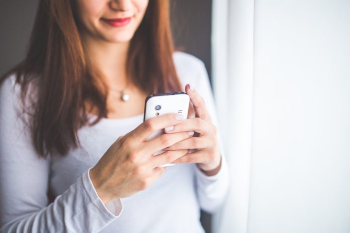 Woman looking at mobile phone Woman looking at mobile phone