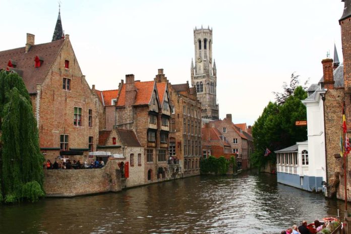 Canal in Bruges with Belfry in the background Canal in Bruges with Belfry in the background