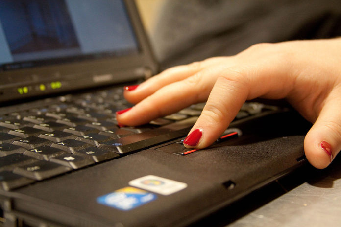woman typing on laptop closeup woman typing on laptop closeup