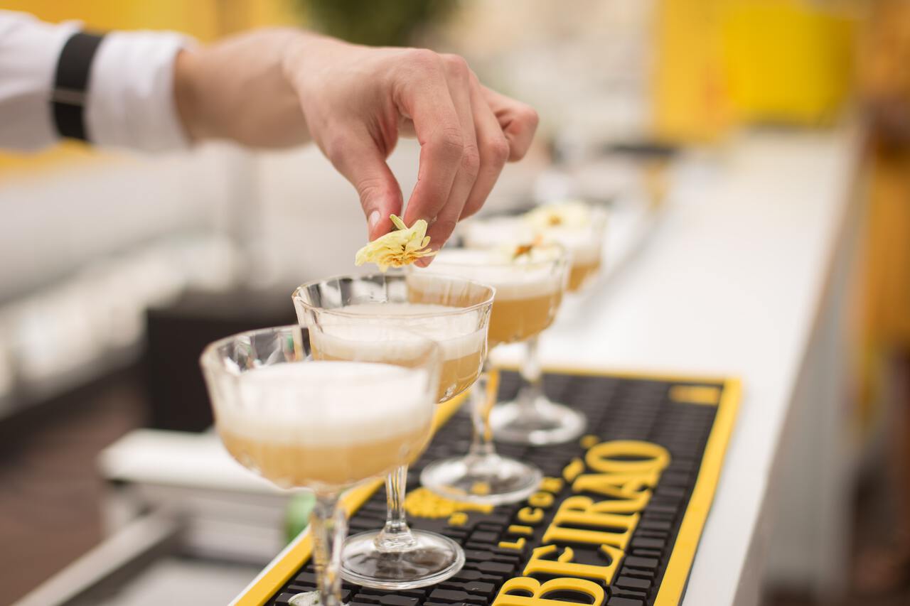 A bartender prepping Aigua de València at a bar near Carrer de Sant Feliu