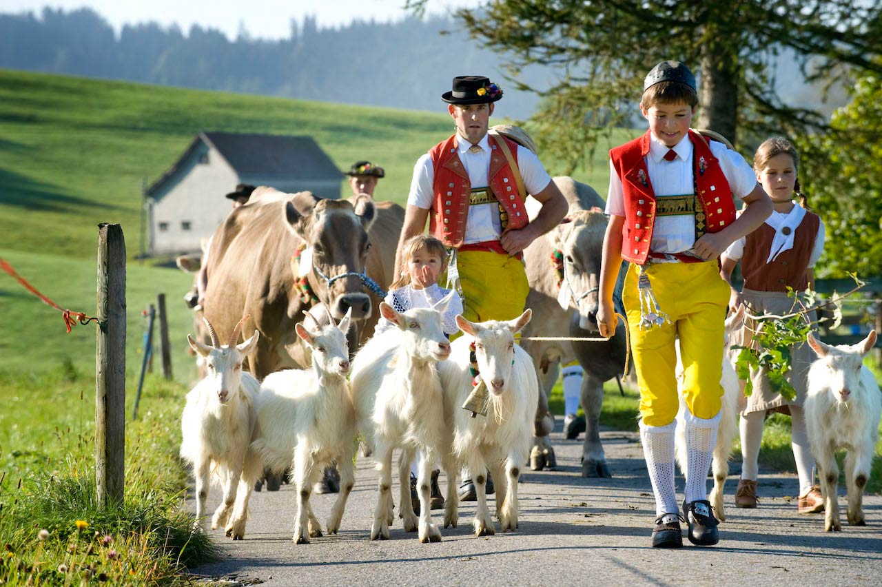 Children and Alpine herdsmen dressed in traditional Appenzell costumes