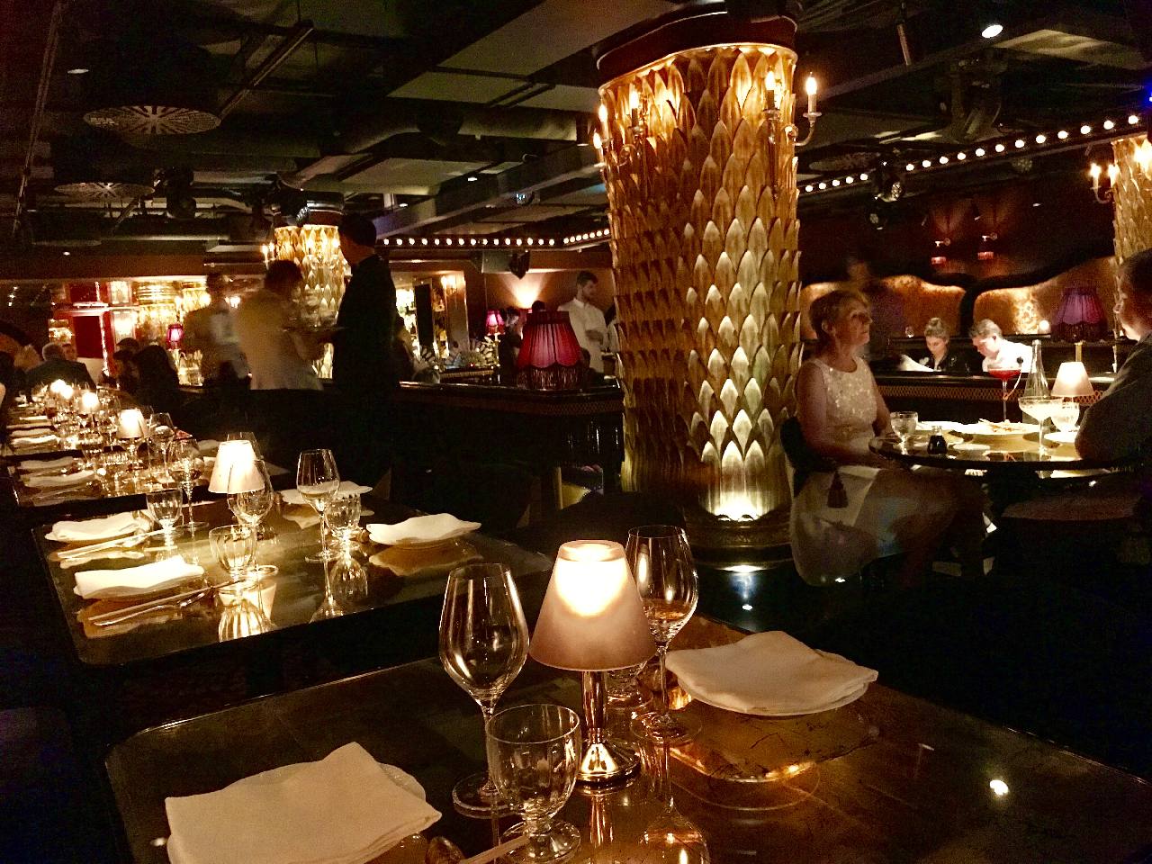 Gold columns in dimly lit dining environment at Club Chinoise, Mayfair