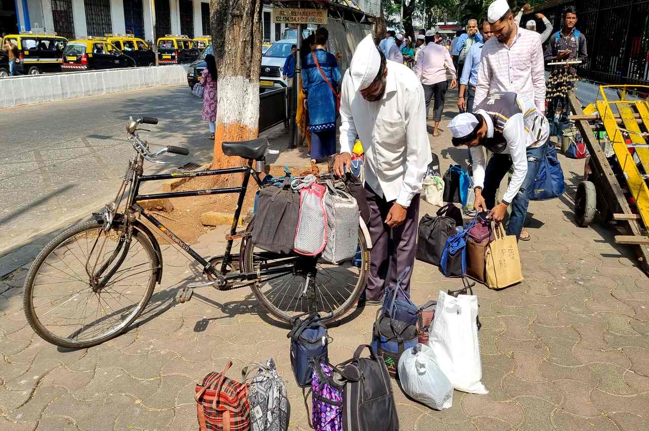 Dabbawallas sorting bagged tiffintins outside Churchgate Railway Station, Mumbai