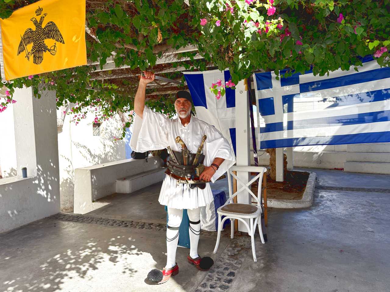 Evzones - Greek soldiers wearing a skirt and clogs with pom poms.