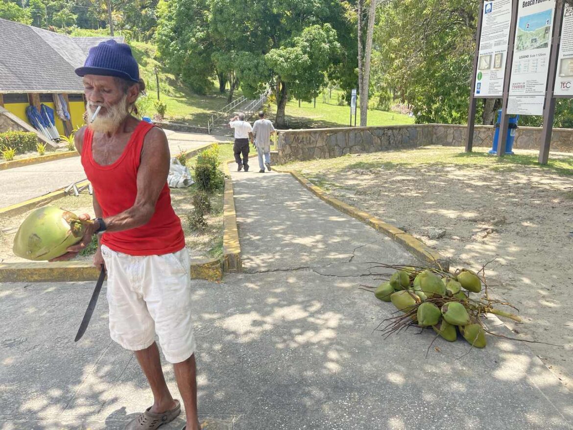 Coconut seller on Las Cuevas Bay beach Trinidad