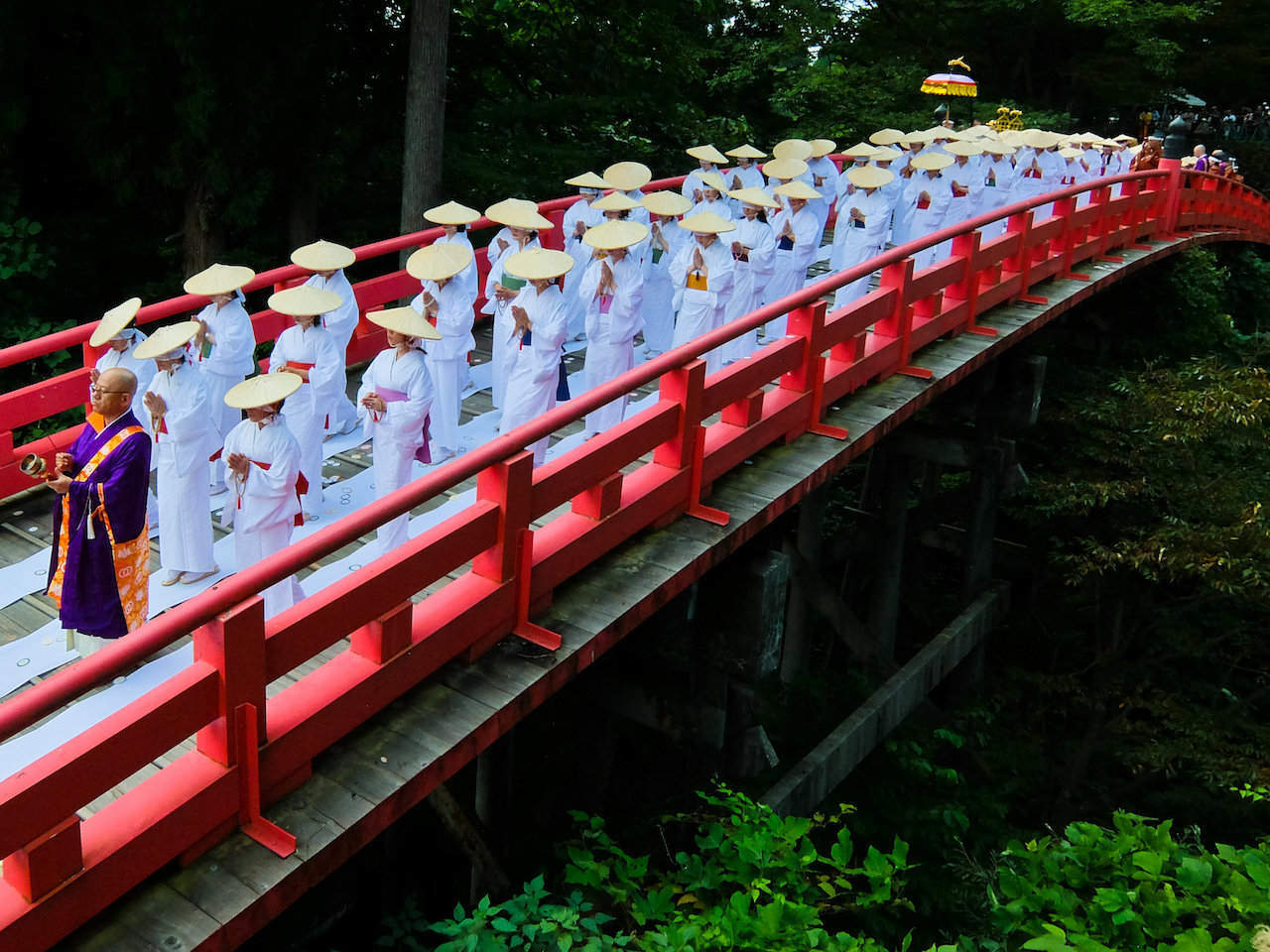 women crossing bridge