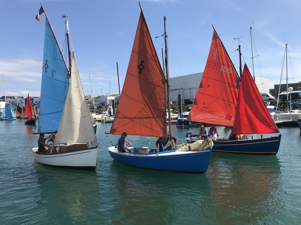 Traditional boats setting out to accompany the skippers at the start of The Golden Globe Yacht Race