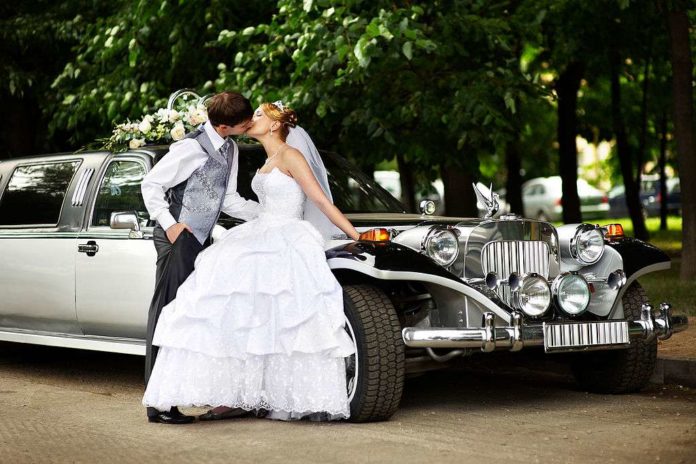 Wedding couple and limousine