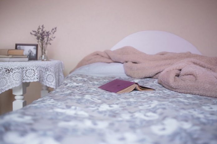 bed with a book and a cover bed with a book and a cover