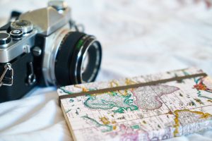 camera and world map notebook