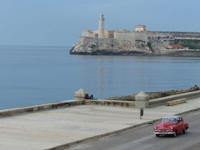 Havana, Cuba: classic car and lighthouse
