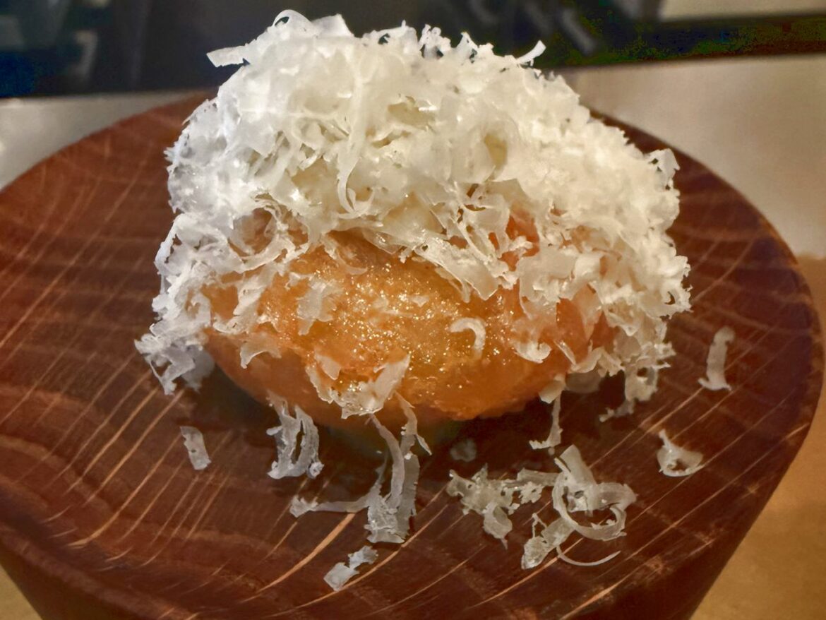 mini doughnut filled with Comte cheese and black truffle sauce at The Cocochine