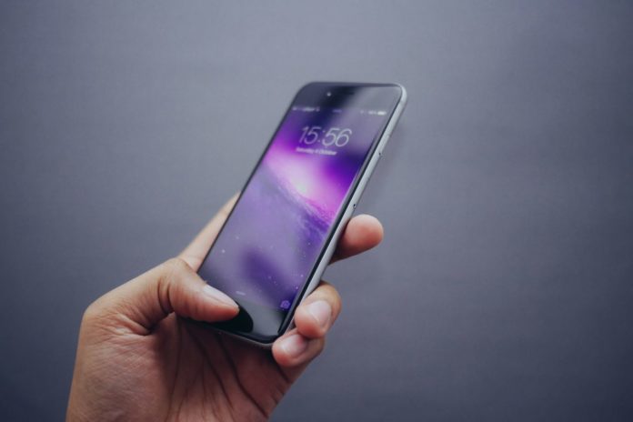 holding a phone Smart phone users can get savvy with their apps