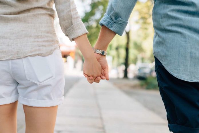 couple holding hands couple holding hands