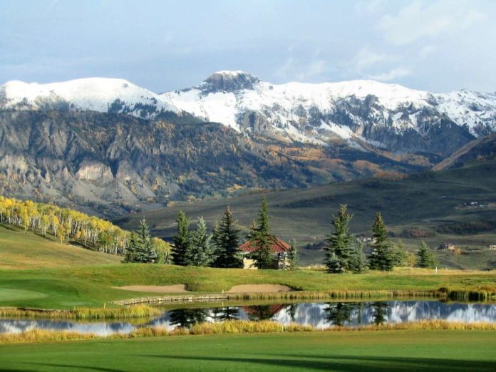 mountain pond trees snow green Colorado mountain pond trees snow green Colorado