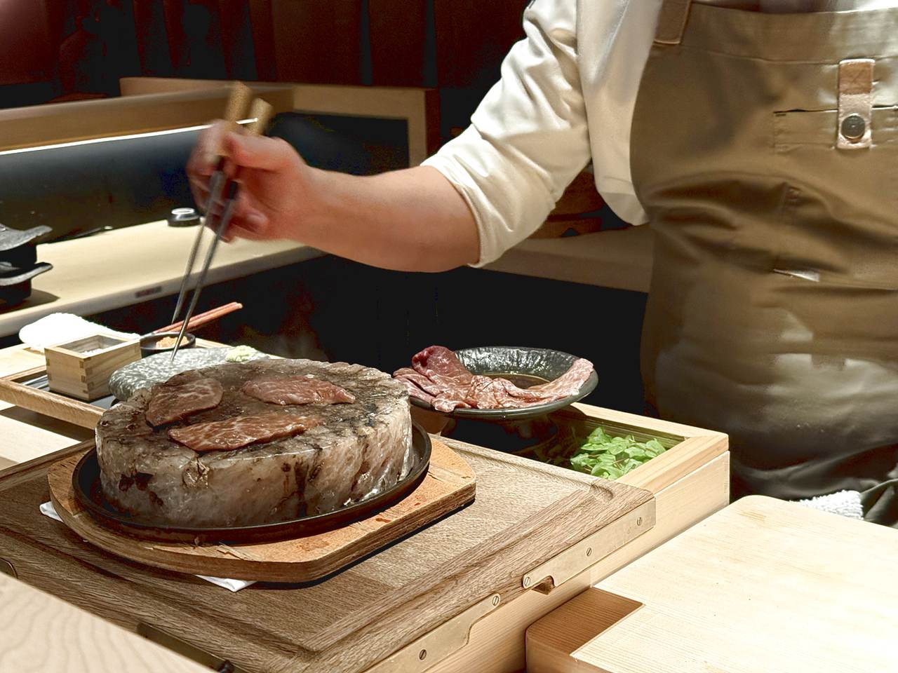 Thin slices of wagyu cooked on a round slab of Himalayan rock salt.