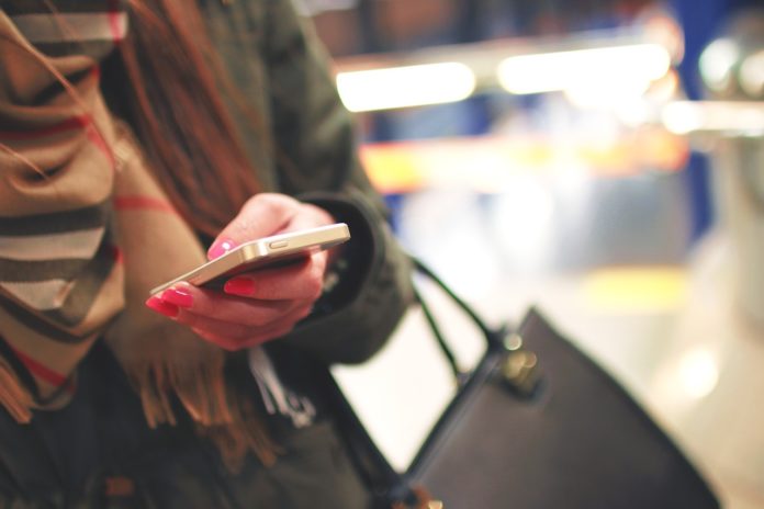 woman texting on iphone woman texting on iphone